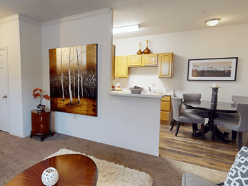 Abilene apartment for rent - A living room with a painting of trees on the wall.