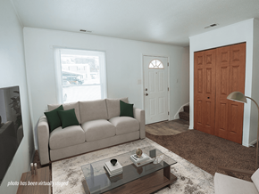 Grand Rapids townhouse for rent - A living room with a couch, coffee table, and a door.