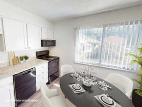 Fort Collins apartment for rent - A black table is set for a meal in a white kitchen.
