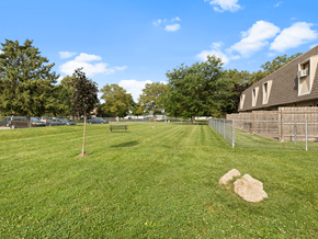 Sandusky apartment for rent - a fenced in dog park with apartments in the background