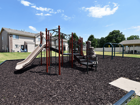 Derby apartment for rent - A playground with a red slide and a brown play structure.