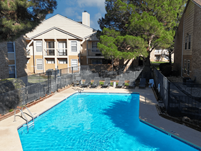Roswell apartment for rent - A swimming pool in a backyard surrounded by a fence.
