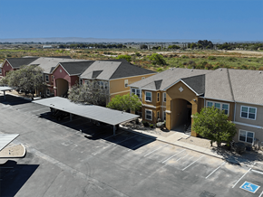 Carlsbad apartment for rent - A parking lot with a building in the background.