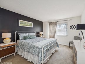 Cincinnati townhouse for rent - a bedroom with a bed and a window