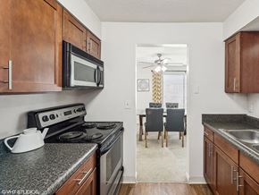Cincinnati townhouse for rent - a kitchen with a stove and microwave and a dining room