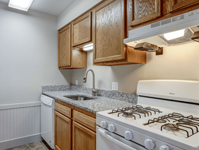 Grand Rapids apartment for rent - a kitchen with wood cabinets and white appliances