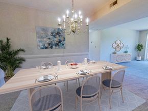 Flint apartment for rent - A dining room with a wooden table set for four.