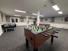 Burnsville apartment for rent - A foosball table is in the middle of a room with a pool table and a foosball table.