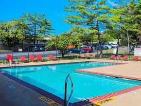 Florissant apartment for rent - A pool with a diving board and a yellow caution tape on the ground.