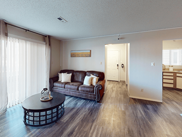 St. Louis apartment for rent - A living room with a brown couch and a coffee table.