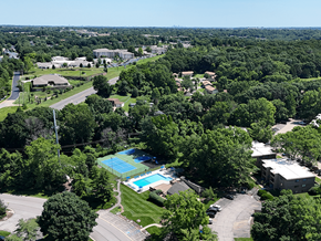 St. Louis apartment for rent - An aerial view of a green campus with a pool.