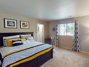 St. Louis apartment for rent - A bedroom with a large bed and two picture frames on the wall.
