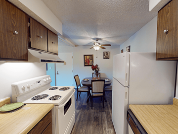 St. Louis apartment for rent - A kitchen with a stove, table and chairs.