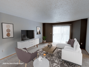 Minot apartment for rent - A living room with a white couch, a brown chair, a white cabinet, a television, a plant, and a rug.