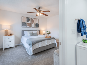 Fayetteville apartment for rent - A bedroom with a bed, nightstand, and a ceiling fan.