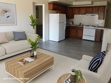 Brooklyn Center apartment for rent - A living room with a white couch and a coffee table with a book on it.