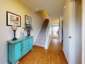 Ballwin townhouse for rent - a living room with stairs and a blue dresser