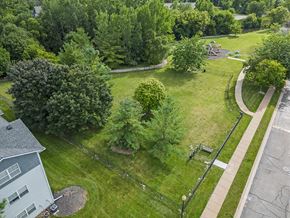 Fenton apartment for rent - an aerial view of a dog park with trees and a sidewalk