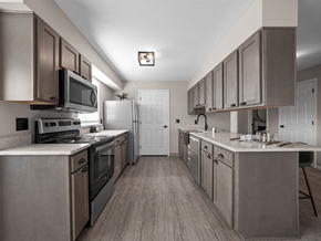 Fenton apartment for rent - a kitchen with stainless steel appliances and white counter tops