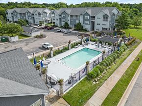 Fenton apartment for rent - an aerial view of a swimming pool in front of an apartment building