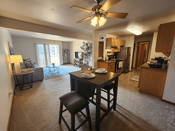 Fitchburg apartment for rent - A living room with a dining table and chairs.