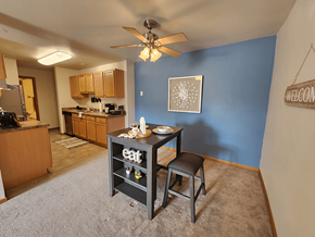 Fitchburg apartment for rent - A kitchen with a dining table and chairs in the middle of the room.