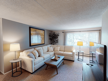Erie townhouse for rent - A living room with a white couch and a painting on the wall.