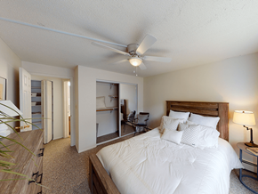 Erie townhouse for rent - A bedroom with a large bed and a ceiling fan.