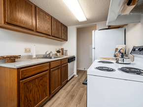 Erie townhouse for rent - A kitchen with wooden cabinets and a white stove top oven.