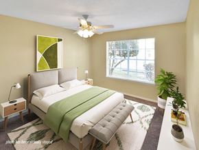Little Rock apartment for rent - A bedroom with a bed, a ceiling fan, and a window.