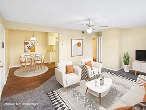 Little Rock apartment for rent - A living room with a white couch, a coffee table, and a ceiling fan.