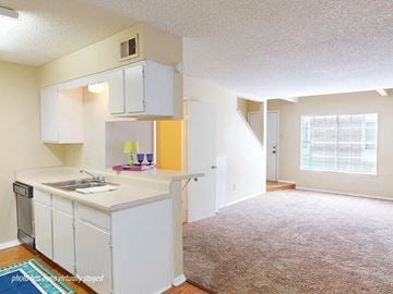 Little Rock apartment for rent - A kitchen with white cabinets and a sink.