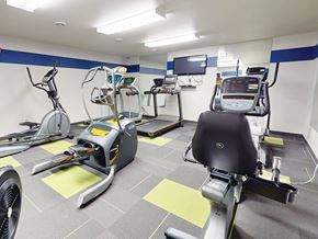 Minot apartment for rent - Cardio exercise equipment including treadmills and stationary bikes at The Chateau Apartments