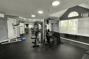 Madison Heights apartment for rent - A black and white photo of a gym with various exercise equipment.