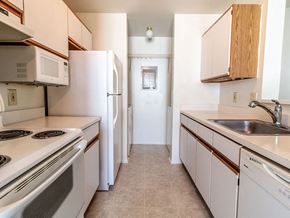 Madison Heights apartment for rent - a kitchen with white appliances and wooden cabinets