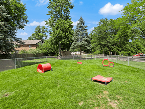 Maumee apartment for rent - fenced in dog park with agility equipment at Whispering Timbers Apartments