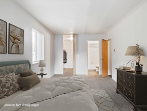Maumee apartment for rent - A bedroom with a large bed and a dresser.