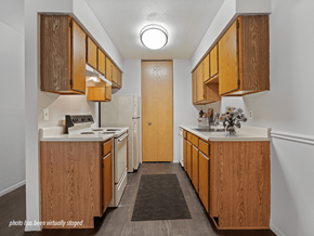 Maumee apartment for rent - A kitchen with wooden cabinets and a white stove top oven.