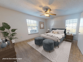 Fayetteville apartment for rent - A bedroom with a bed, nightstand, and a plant.