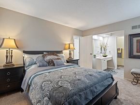 Kansas City triplex for rent - a bedroom with a bed and a bathroom with a sink