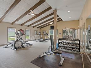 Kansas City triplex for rent - a gym with a lot of exercise equipment in it