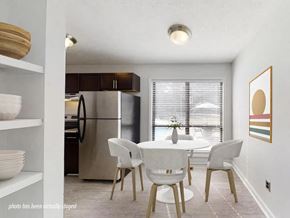 Fayetteville apartment for rent - A kitchen with a table and chairs in front of a window.