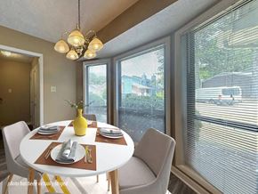 Fayetteville apartment for rent - A dining room with a table set for two and a view of the street outside.