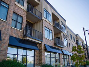 Minot apartment for rent - a brick apartment building with awnings