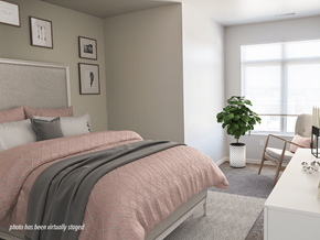 Minot apartment for rent - A bedroom with a pink bedspread and a grey blanket.