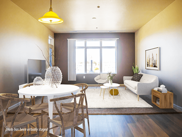 Minot apartment for rent - A living room with a white table and chairs, a couch, a television, and a window.