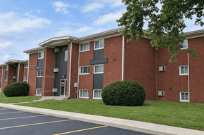 Decatur apartment for rent - A red brick apartment building with a parking lot in front.