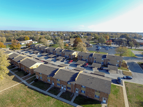 Decatur apartment for rent - A row of houses with a parking lot in front.