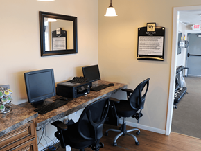 Decatur apartment for rent - A black computer monitor and keyboard on a desk with a black chair.
