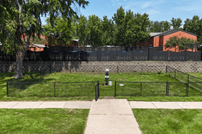 Cedar Rapids apartment for rent - A black fence surrounds a green field.
